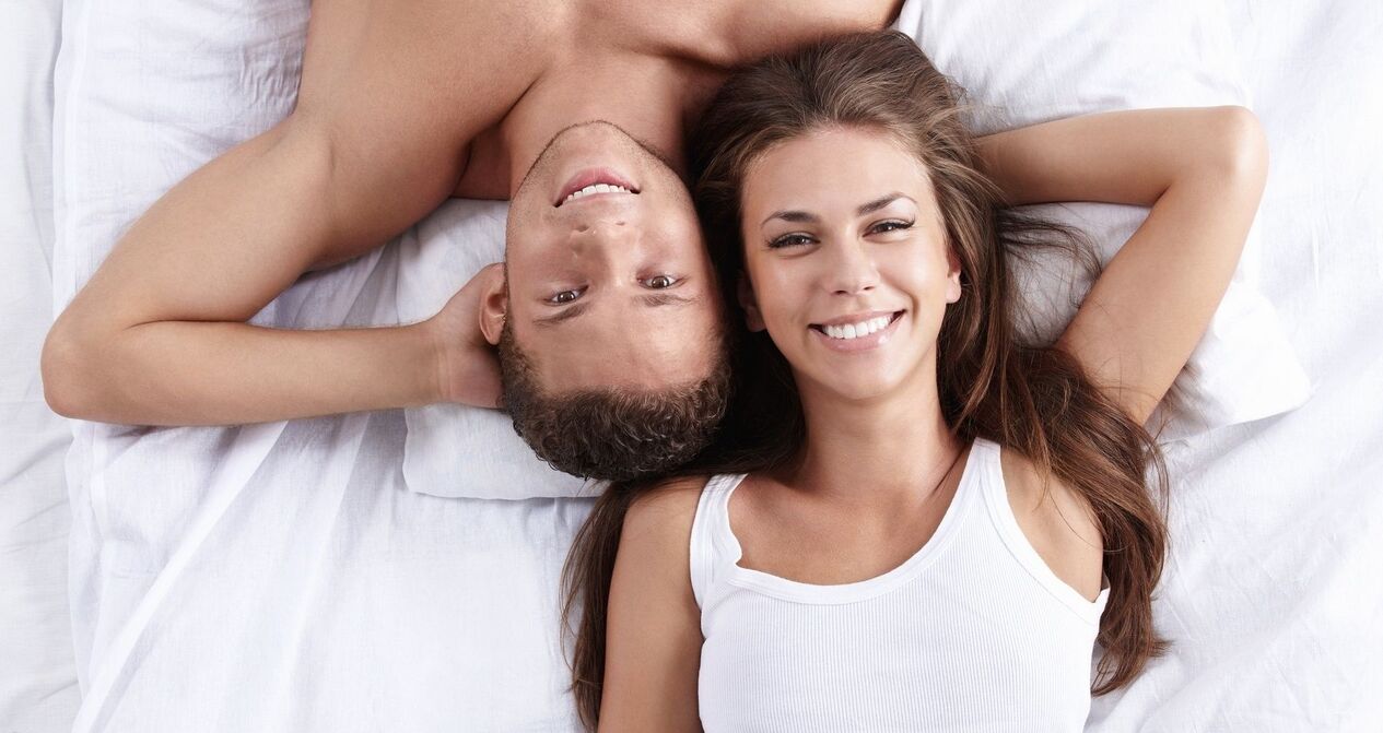 a woman in bed with a man of increased potency